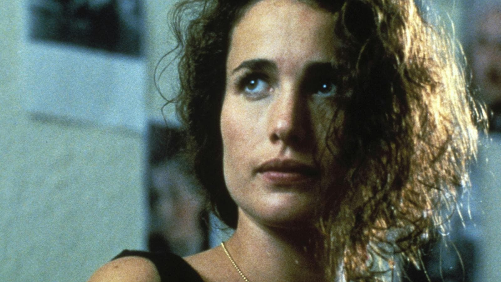 Woman with disheveled hair looking past the camera