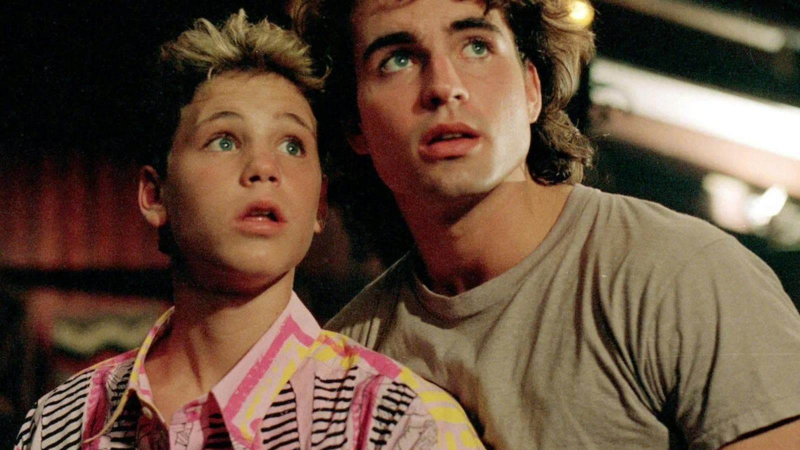 Two young boys looking up frightened