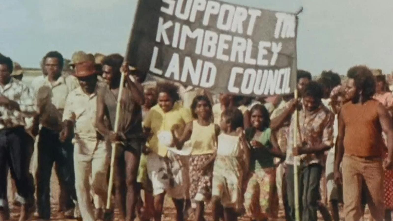 Protest with group of people holding sign saying support to Kimberley land council