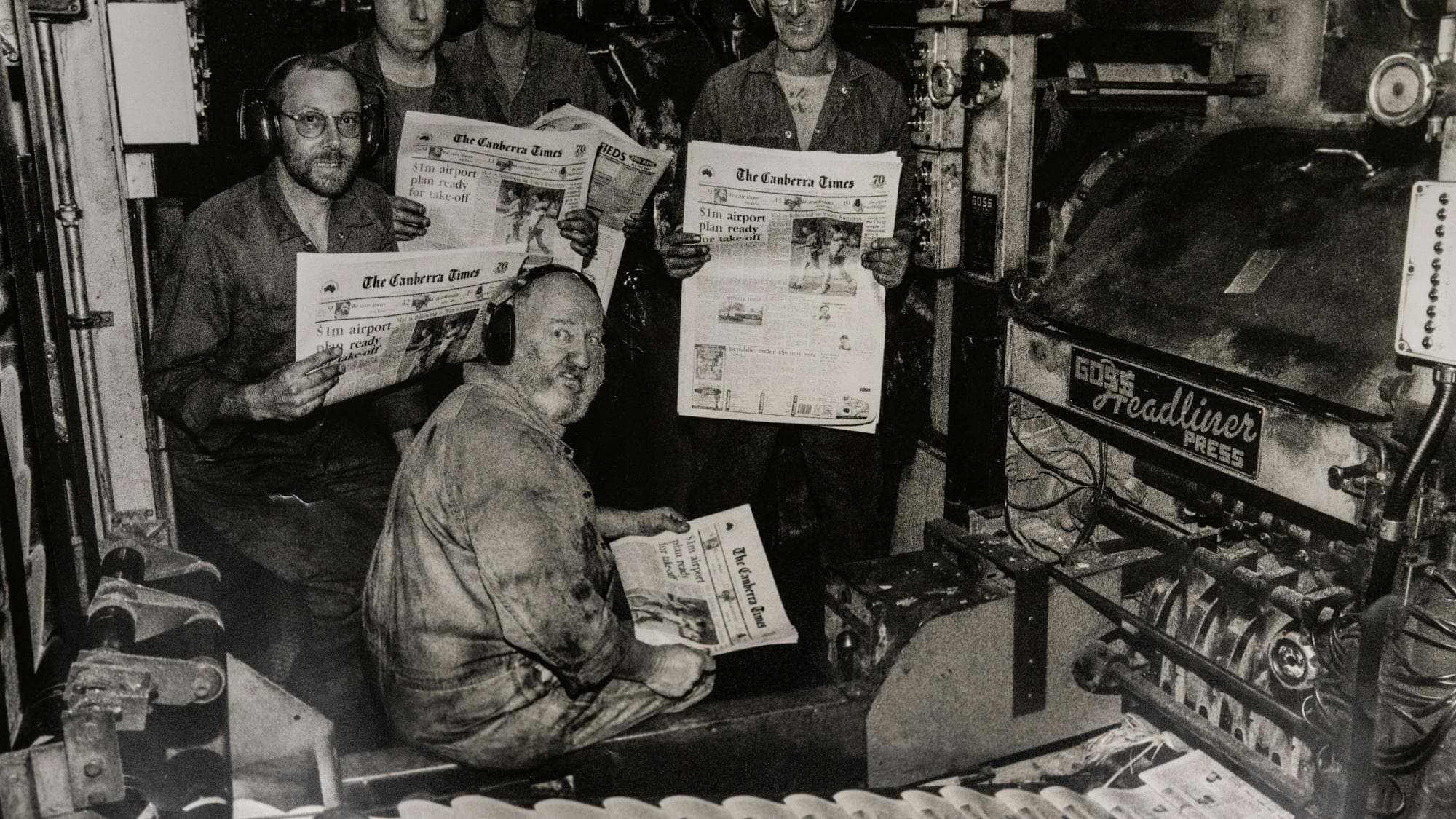 1996 Canberra Times printing press with workers holding copies of the newspaper