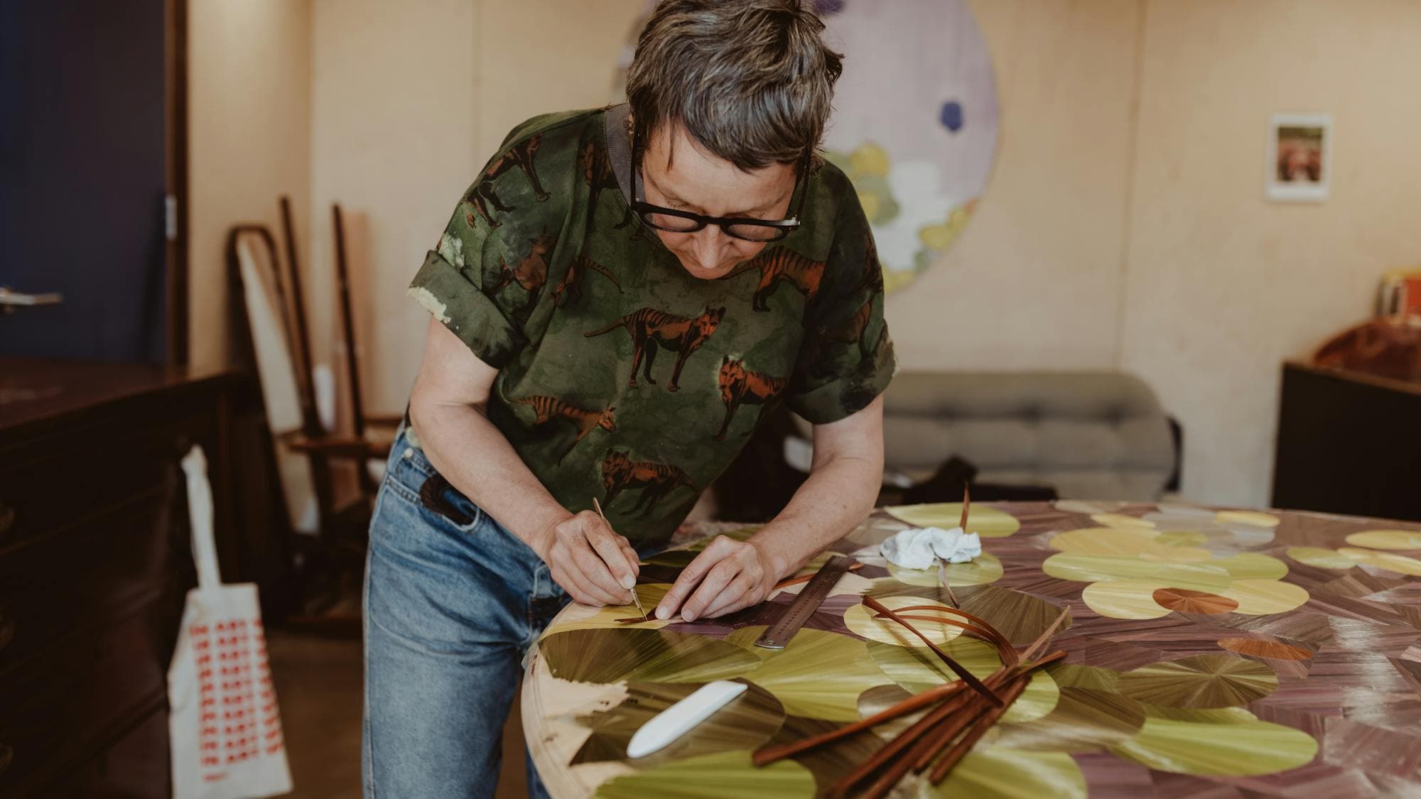 Inke Falkner using the technique of French straw marquetry on her artwork Round and Round